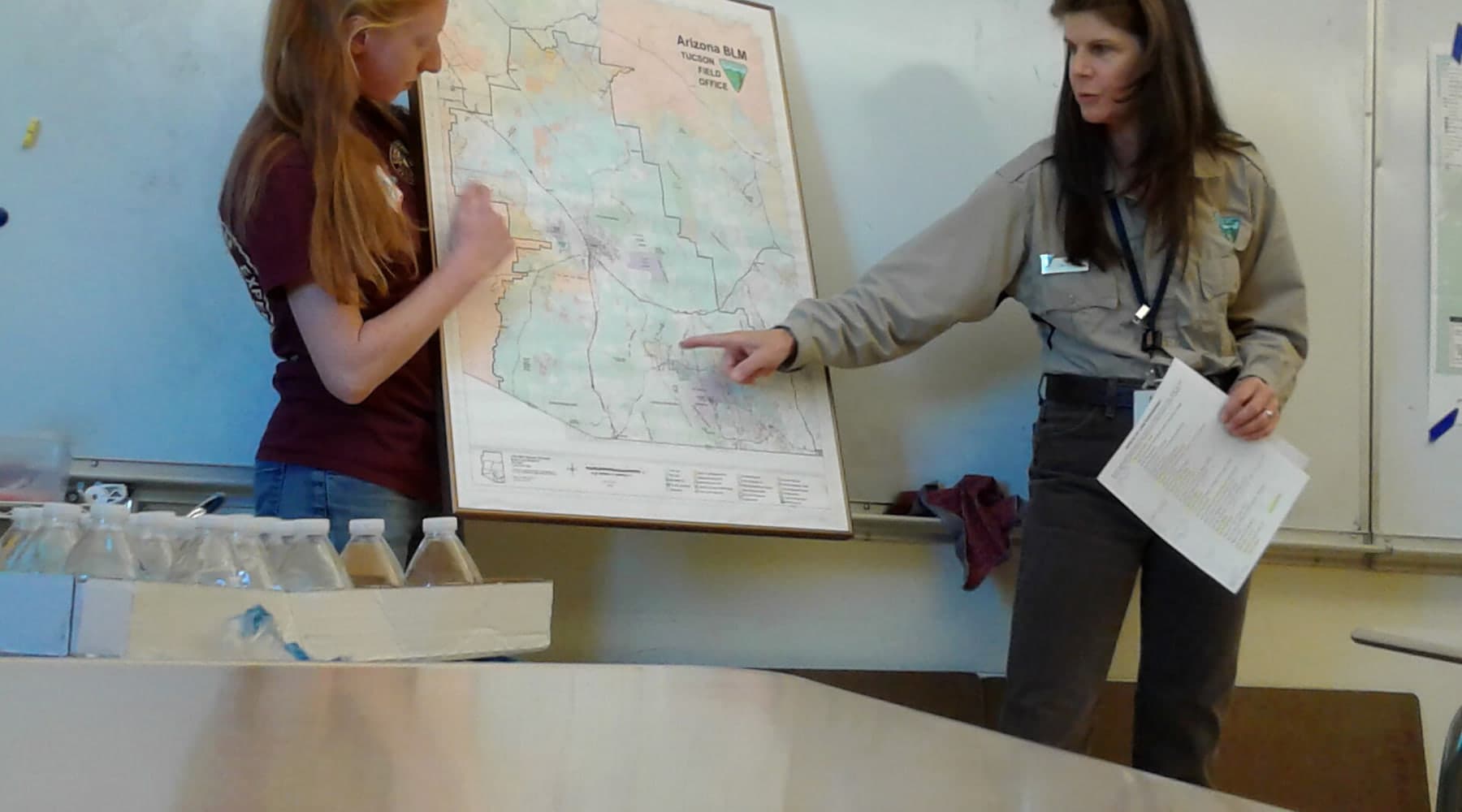 Land management professionals reviewing maps and source records